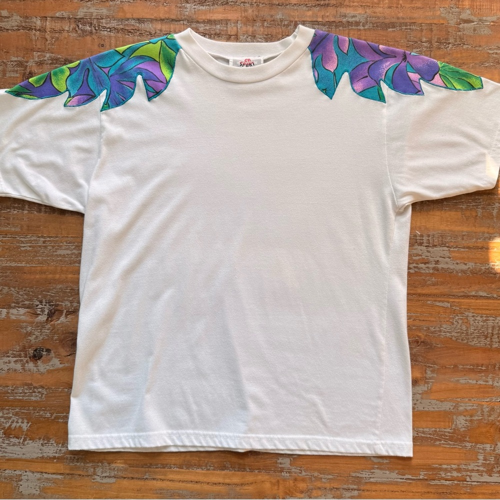 Vintage 90s CA Sport white tshirt with floral leaf design on sleeves.